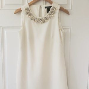 Short sleeveless dress with decorative neckline